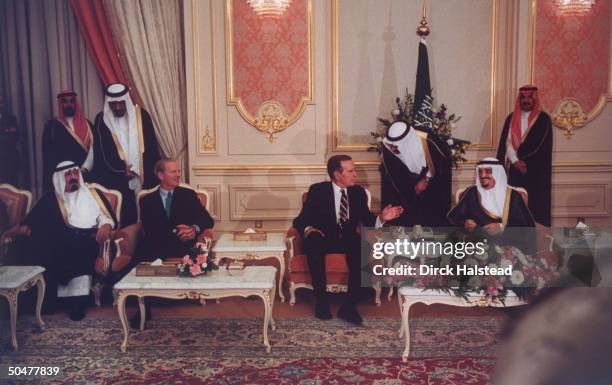 Saudi Prince Abdullah, US State Secy. Jim Baker, Pres. Bush & King Fahd, sitting, discussing gulf crisis, w. Translators assist- ing, hovering over.