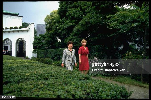1st Lady Hillary Rodham Clinton strolling grounds of US Amb.'s residence w. Her Russian counterpart Naina Yeltsin during G7 summit.