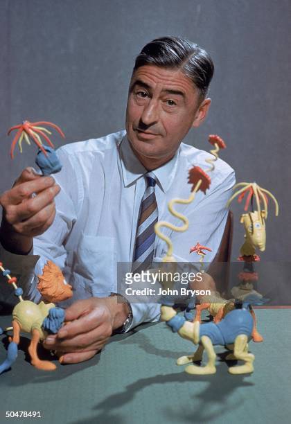 Children's book author/illustrator Theodor Seuss Geisel poses with models of some of the characters he has created.