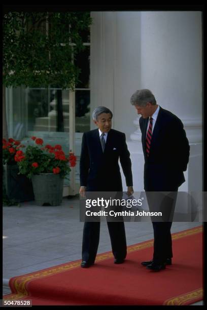 Pres. Bill Clinton treading red carpet w. Japanese Emperor Akihito, chatting, during WH N. Portico departure fete.