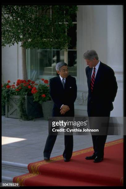 Pres. Bill Clinton treading red carpet w. Japanese Emperor Akihito, chatting, during WH N. Portico departure fete.