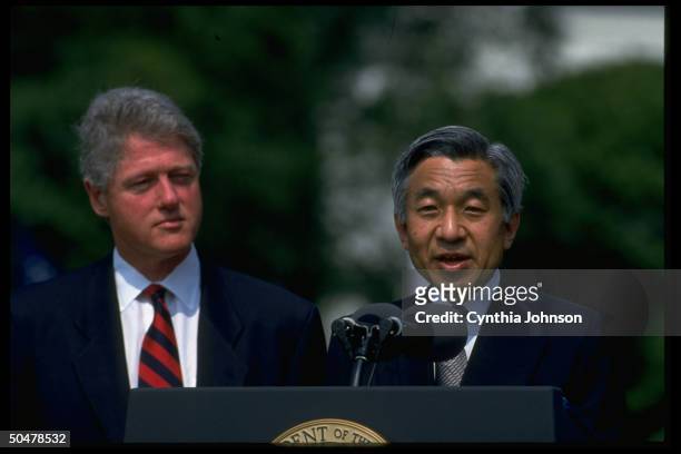 Pres. Bill Clinton listening to Japanese Emperor Akihito speak during WH S. Lawn arrival ceremony.