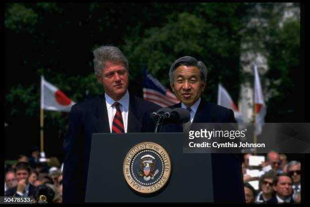 Pres. Bill Clinton listening to Japanese Emperor Akihito speak during WH S. Lawn arrival ceremony.