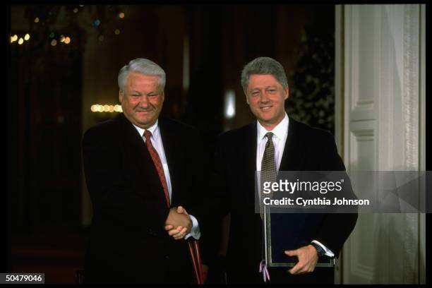 Pres. Bill Clinton & Russian Pres. Boris Yeltsin shaking hands during accord signing ceremony in WH E. Rm.