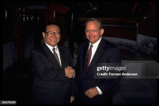 Chinese Pres. Jiang Zemin shaking hands w. US Natl. Security Adviser Tony Lake before sitting down to talks.