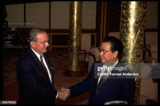 Chinese Premier Li Peng shaking hands w. US Natl. Security Adviser Tony Lake before sitting down to talks.