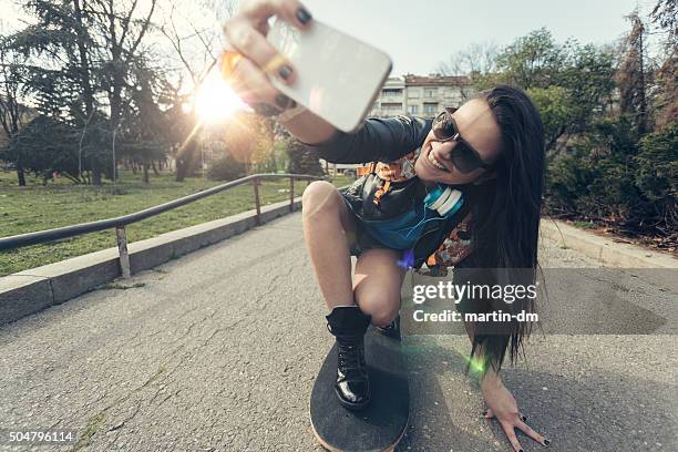 teenage girl taking a selfie at a skateboard - longboard skating stock pictures, royalty-free photos & images