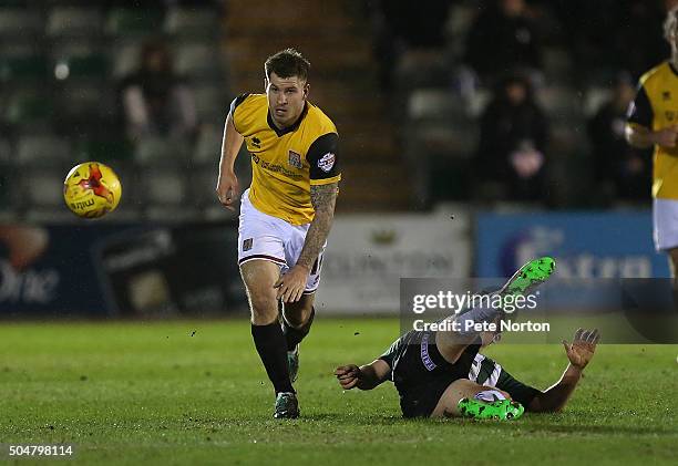 James Collins of Northampton Town moves away with the ball from the challenge of Carl McHugh of Plymouth Argyle during the Sky Bet League Two match...