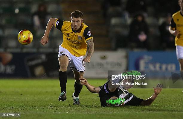 James Collins of Northampton Town moves away with the ball from the challenge of Carl McHugh of Plymouth Argyle during the Sky Bet League Two match...