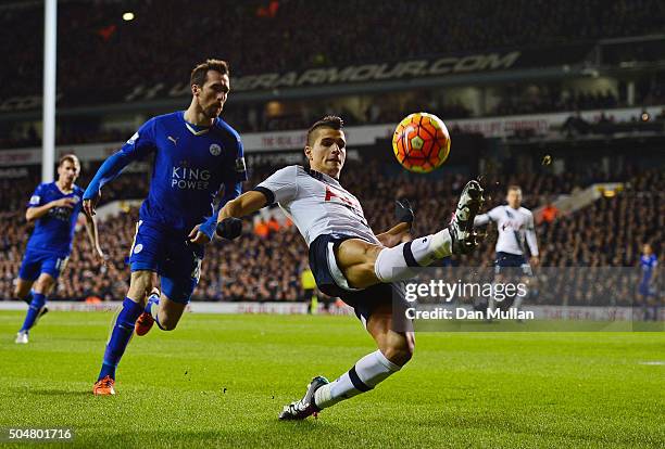 Erik Lamela of Tottenham Hotspur and Christian Fuchs of Leicester City compete for the ball during the Barclays Premier League match between...