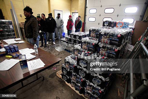 Flint residents get bottled water, water testing kits, and water filters at a Flint Fire Station January 13, 2016 in Flint, Michigan. On Tuesday,...