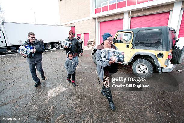 Flint residents get bottled water, water testing kits, and water filters at a Flint Fire Station January 13, 2016 in Flint, Michigan. On Tuesday,...