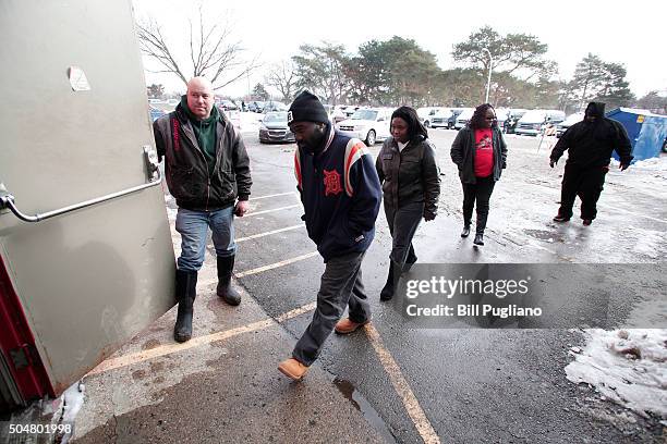 Flint residents enter a Flint Fire Station to get bottled water, water testing kits, and water filters January 13, 2016 in Flint, Michigan. On...