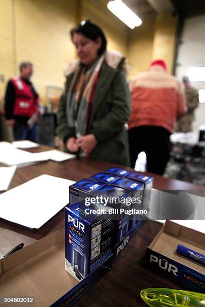 Flint residents get bottled water, water testing kits, and water filters at a Flint Fire Station January 13, 2016 in Flint, Michigan. On Tuesday,...