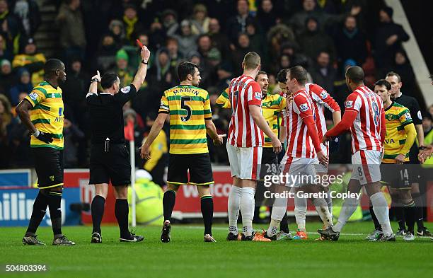 Gary O'Neil of Norwich City is shown a red card by referee Neil Swarbrick during the Barclays Premier League match between Stoke City and Norwich...
