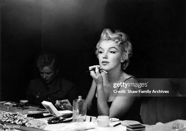 Marilyn Monroe getting ready at a makeup table in 1955 in New York, New York.