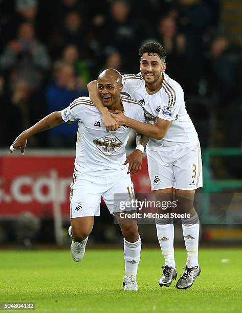 Andre Ayew of Swansea City celebrates scoring his team's second goal with his team mate Neil Taylor during the Barclays Premier League match between...