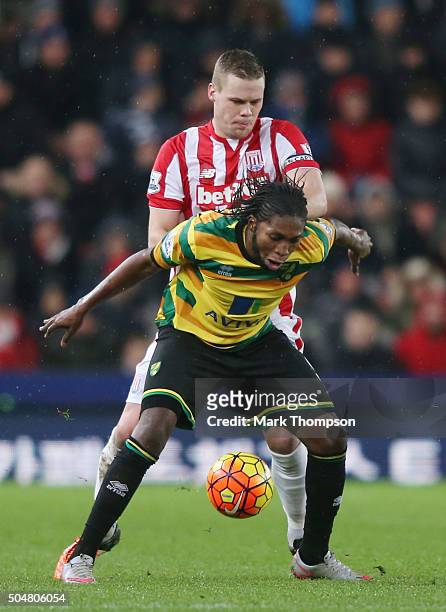 Dieumerci Mbokani of Norwich City controls the ball under pressure of the Ryan Shawcross of Stoke City during the Barclays Premier League match...