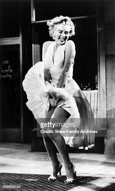 Marilyn Monroe standing over a subway grate with her white dress blowing in 1954 during the filming of "The Seven Year Itch" in Los Angeles,...