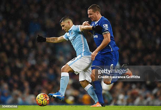 Sergio Aguero of Manchester City and Phil Jagielka of Everton compete for the ball during the Barclays Premier League match between Manchester City...