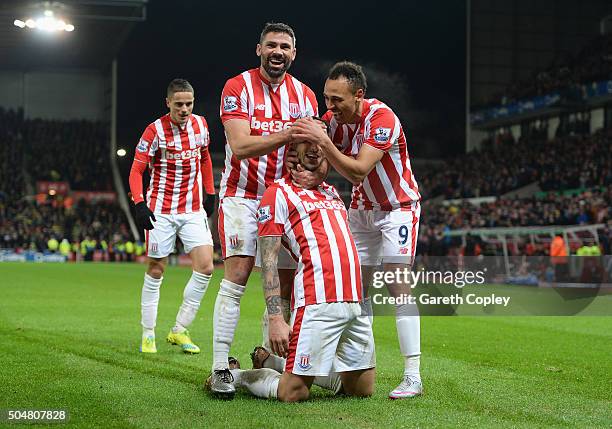 Joselu of Stoke City celebrates scoring his team's second goal with his team mates Ibrahim Afellay , Jonathan Walters and Peter Odemwingie of Stoke...