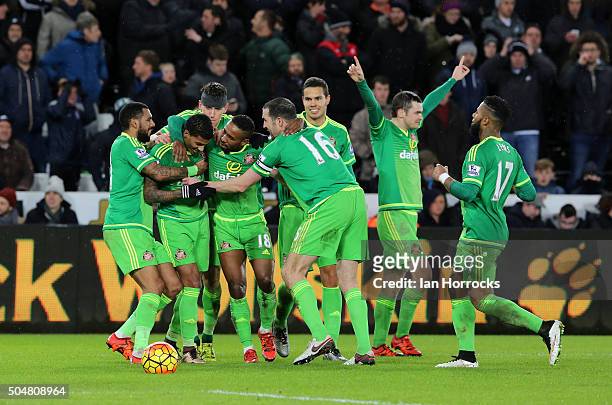 Sunderland players celebrate the fourth Sunderland goal around Jermain Defoe during the Barclays Premier League Match between Swansea City and...