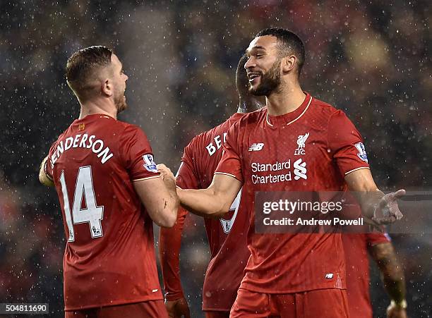 Jordan Henderson of Liverpool shakes hands with Steven Caulker of Liverpool at the end of the Barclays Premier League match between Liverpool and...