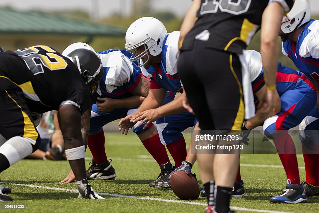 Sports: Football teams prepare for a play. Line of scrimmage.