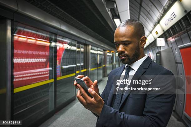 business man on the phone inside the london tube metro - glory tube 個照片及圖片檔