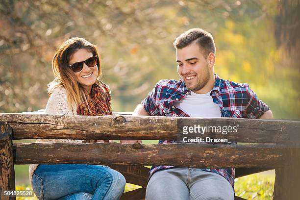 romantic attractive couple hugging and loving in city park - novi sad stockfoto's en -beelden