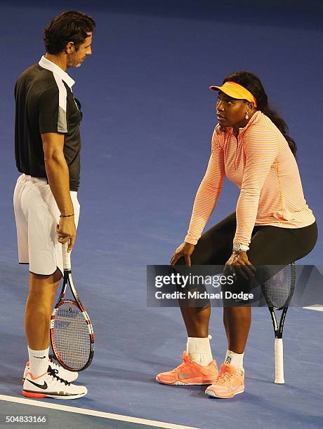 Serena Williams of the USA talks with coach coach Patrick Mouratoglou while sitting on her racquet during a practice session ahead of the 2016...