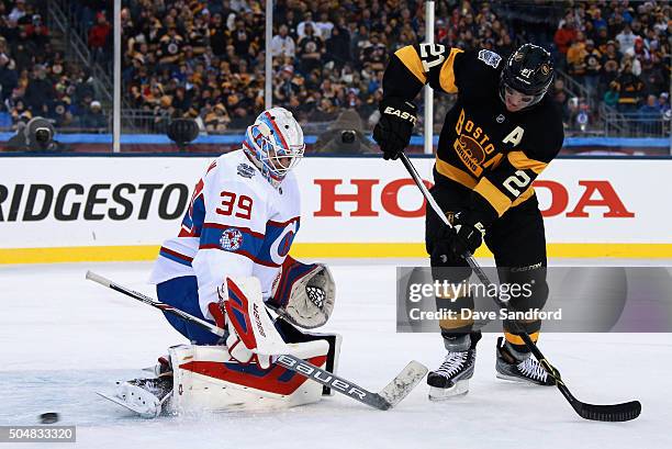 Goaltender Mike Condon of the Montreal Canadiens plays against Loui Eriksson of the Boston Bruins during the 2016 Bridgestone NHL Classic at Gillette...