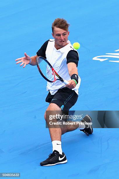 Omar Jasika of Australia plays a backhand in his match against Kyle Edmund of Great Britain during day three of the 2016 Kooyong Classic at Kooyong...