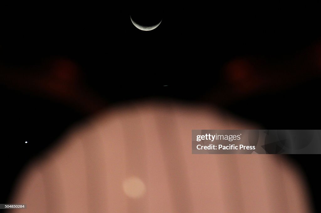 Crescent moon on the West horizon during the night. The...