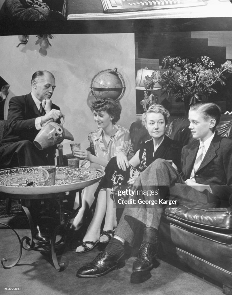 Ely Culbertson relaxing with unidentified people. News Photo - Getty Images