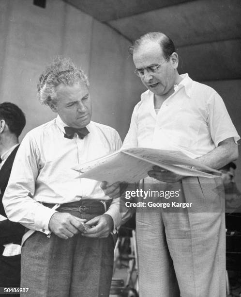 Conductor Max Steiner discussing the score for singer Frank Sinatra's song w. His assist. During rehearsal for the crooner's guest spot w. The New...