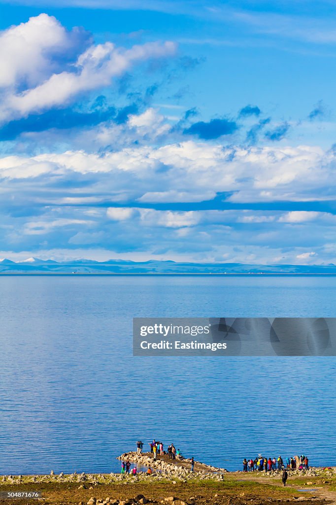 Tourist in Qinghai Lake and cloudy sky