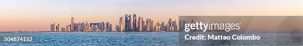 high res panoramic of doha skyline at sunset, qatar - doha skyline stock-fotos und bilder