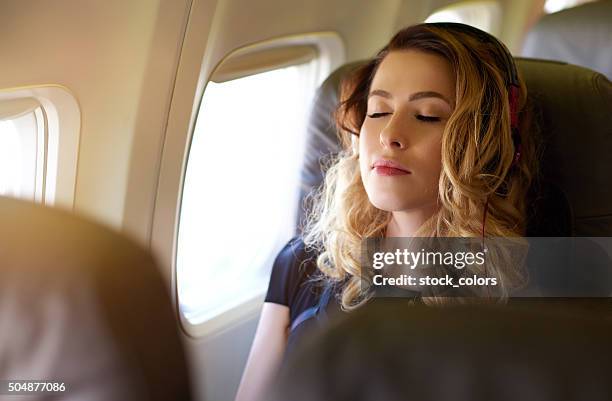 enjoy my relaxing flying - woman airplane headphones bildbanksfoton och bilder