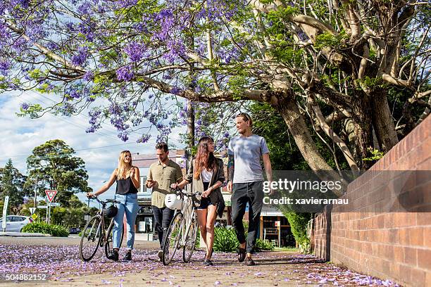 australian friends walking in the street on a sunny day - pedestrian stock pictures, royalty-free photos & images