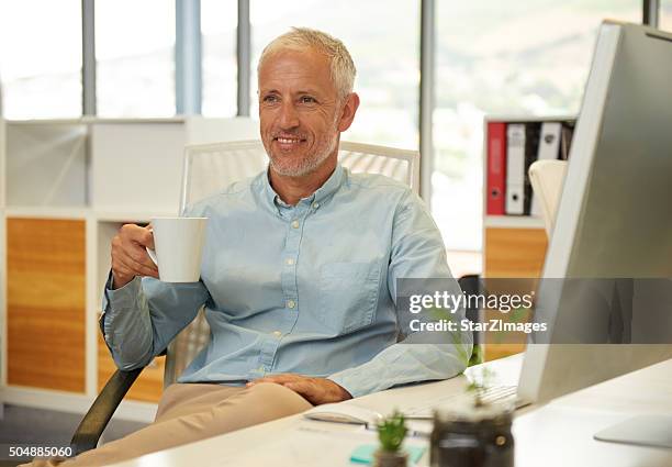 portrait of businessman near his desk - open collar stock pictures, royalty-free photos & images