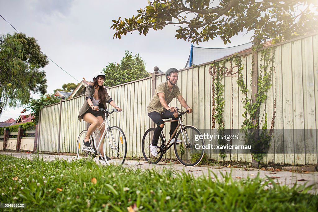 Australian mid adult couple riding bikes back home