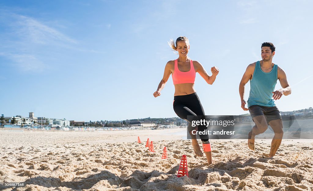 Couple exercising outdoors at the beach