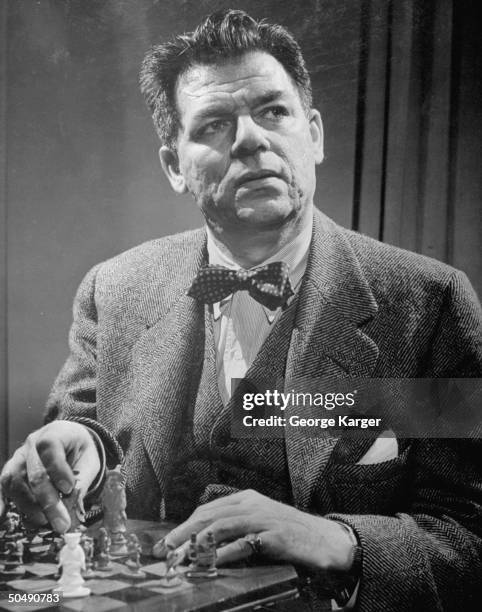 Composer Oscar Hammerstein II posing for a picture at his home.