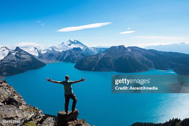 celebrating a personal victory in stunning nature - british columbia stock pictures, royalty-free photos & images