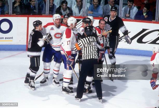 Referee Andy Van Hellemond tries to break up a confrontation between John LeClair of the Montreal Canadiens and Rob Blake of the Los Angeles Kings as...