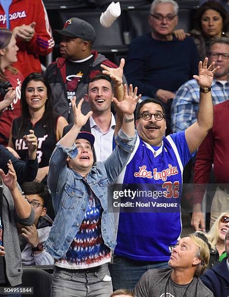 Adam DeVine and Erik Griffin attempt to grab a shirt at a basketball game between the Miami Heat and the Los Angeles Clippers at Staples Center on...