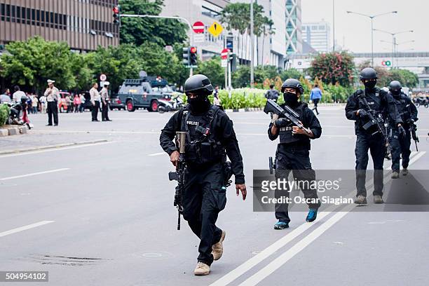 Indonesian policemen guard the blast site after a series of explosions hit the Indonesia capital on January 14, 2016 in Jakarta, Indonesia. Reports...