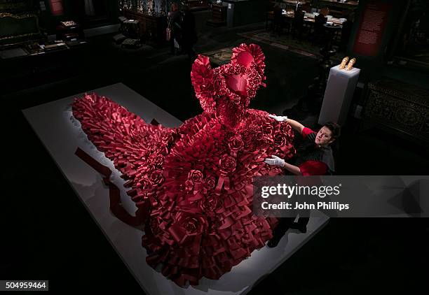 British Artist Zoe Bradle makes finishing touches to her monumental red paper dress sculpture containing 5,940 ruffles at Sotheby's on January 14,...