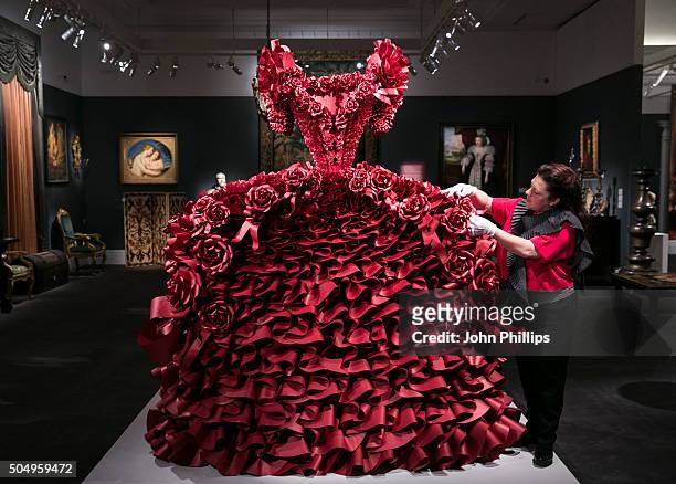 British Artist Zoe Bradle makes finishing touches to her monumental red paper dress sculpture containing 5,940 ruffles at Sotheby's on January 14,...
